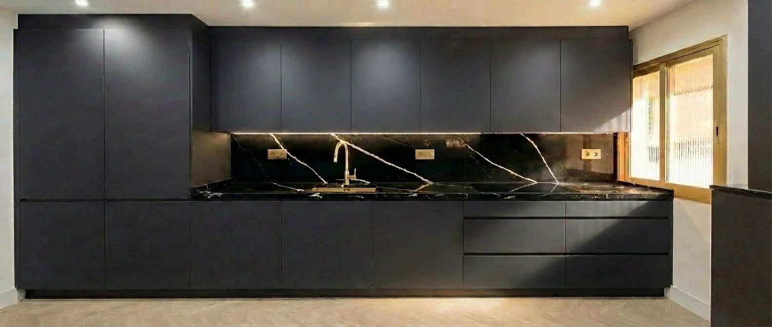 Cocina a medida negra con mármol Sahara Noir, vista cuidada